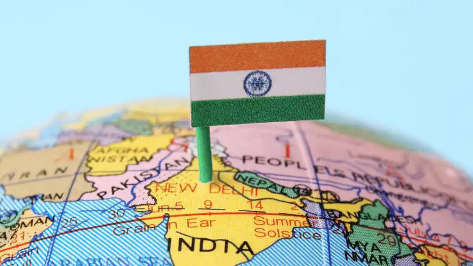 Elderly Indian couple relaxing in their home garden